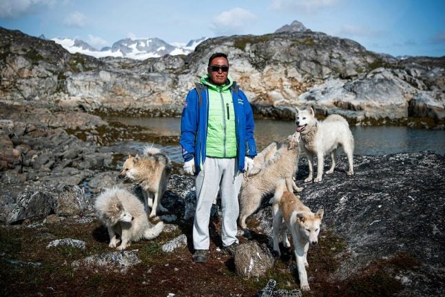 In Greenland village, shorter winters cast doubts over dog sledding